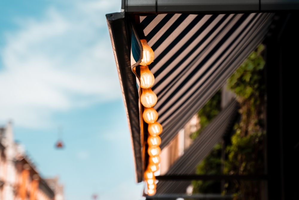 Black aesthetic awnings with warm white light bulbs